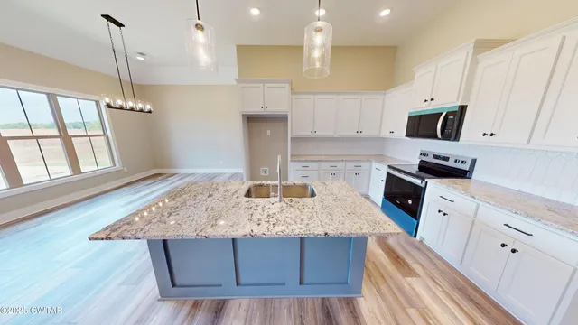 a kitchen with a stove a sink and a refrigerator