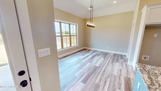 a view of an entryway with wooden floor