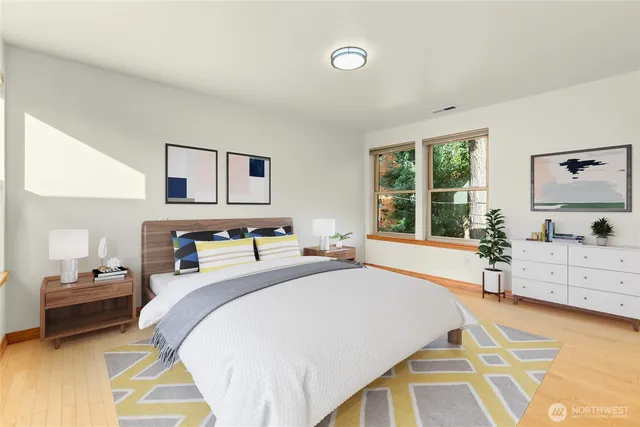 a bedroom with a bed and a large window