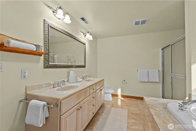 a bathroom with a double vanity sink mirror and