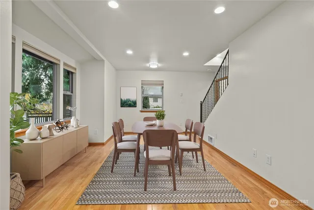 a dining room with furniture and wooden floor