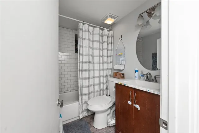 a bathroom with a sink toilet and shower