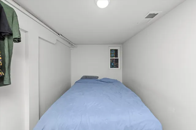 a view of a big room with wooden floor and windows