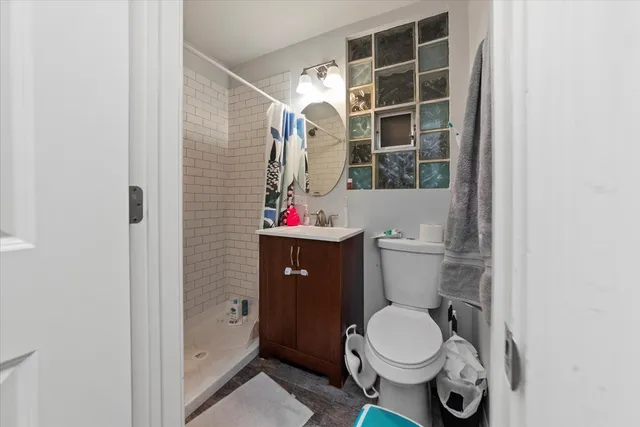 a bathroom with a toilet and a shower