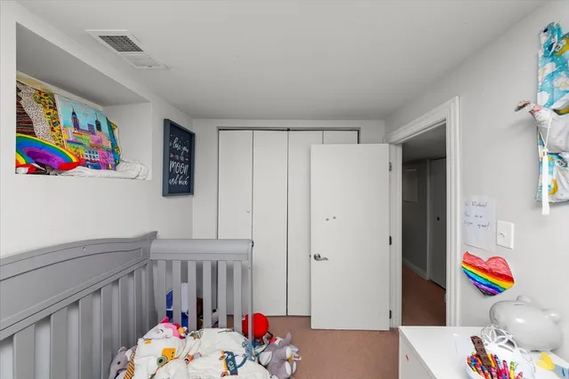 a bedroom with baby crib and hanging chair