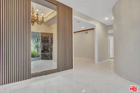 a view of a big room with windows and entryway