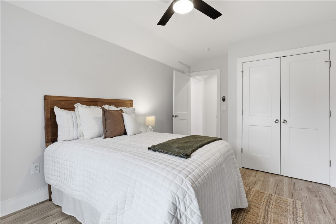 1 Brock Street Pelzer, SC 29669 - Photo 19 of 25 Relax and unwind in this naturally illuminated primary bedroom featuring ample closet space and a modern ceiling fan.