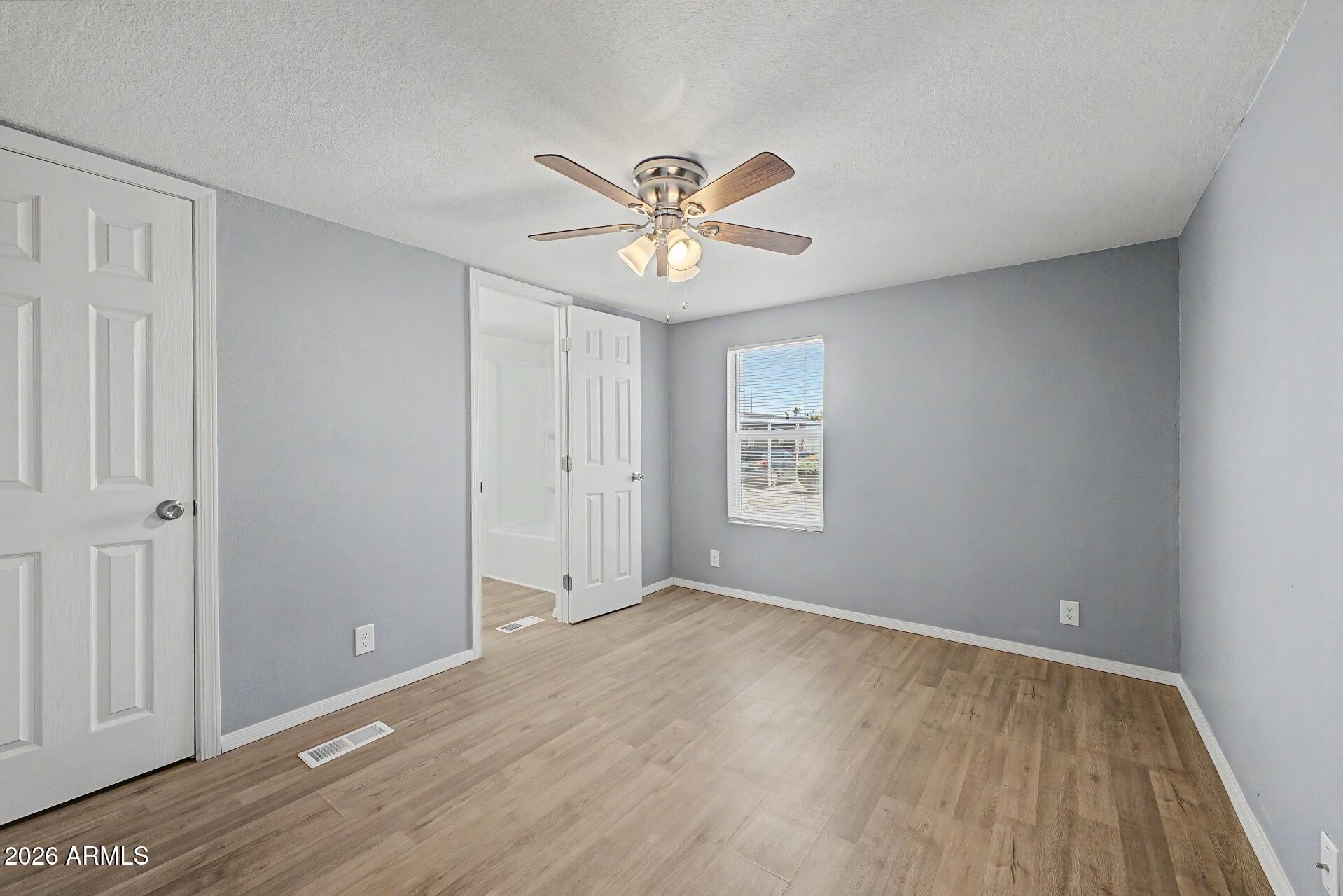 320 East McKellips Road, Unit 58 Mesa, AZ 85201 - Photo 12 of 22 a view of room with a ceiling fan and window