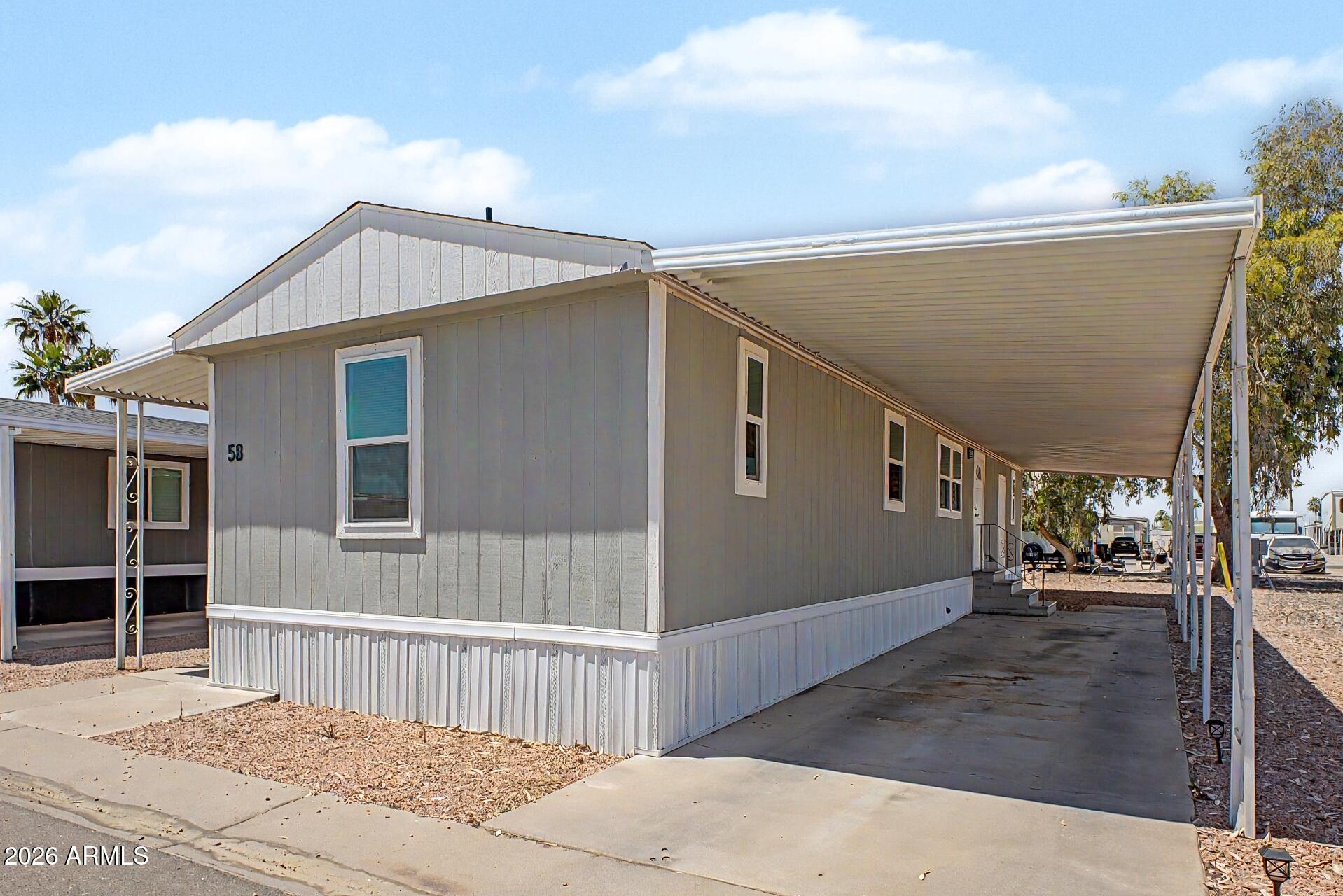 320 East McKellips Road, Unit 58 Mesa, AZ 85201 - Photo 3 of 22 a view of a house with a backyard