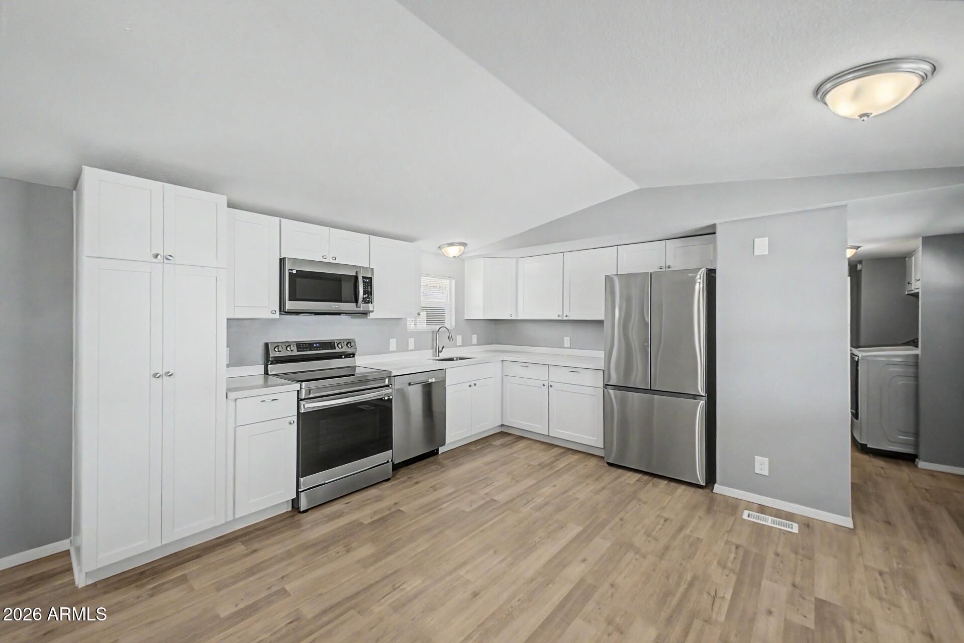 320 East McKellips Road, Unit 58 Mesa, AZ 85201 - Photo 9 of 22 a kitchen with stainless steel appliances a refrigerator sink and stove