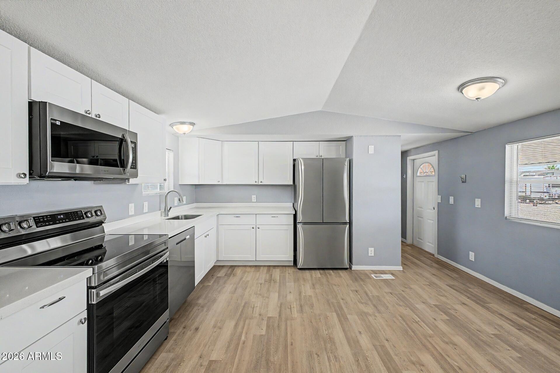 320 East McKellips Road, Unit 58 Mesa, AZ 85201 - Photo 10 of 22 a kitchen with a refrigerator stove and sink