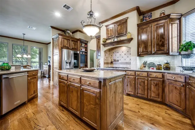 a kitchen with stainless steel appliances granite countertop a stove and a sink