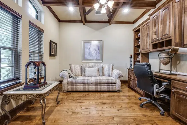 a living room with furniture a dining table and a flat screen tv