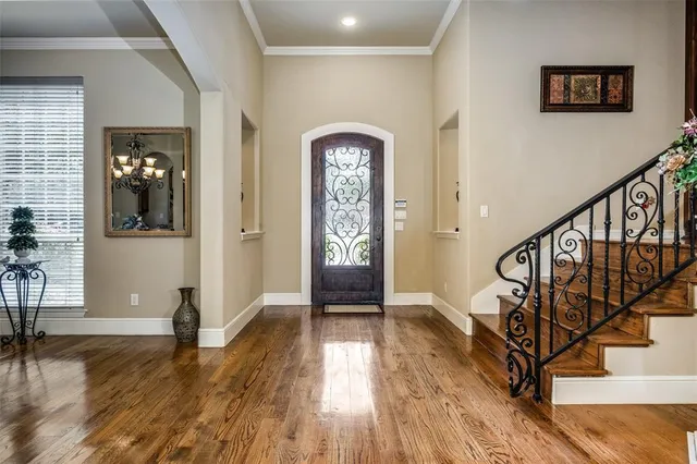 a view of an entryway with wooden floor and stairs
