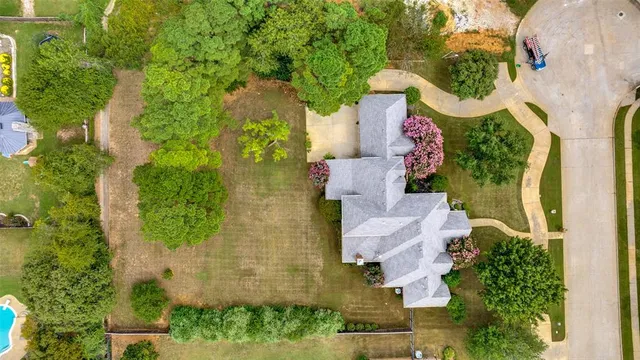 an aerial view of a house with a yard and garden