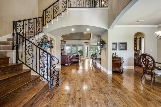 a view of entryway and hall with wooden floor