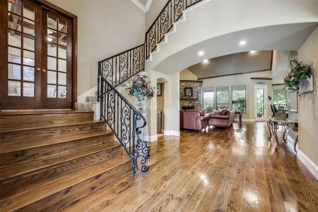 a view of entryway and hall with wooden floor