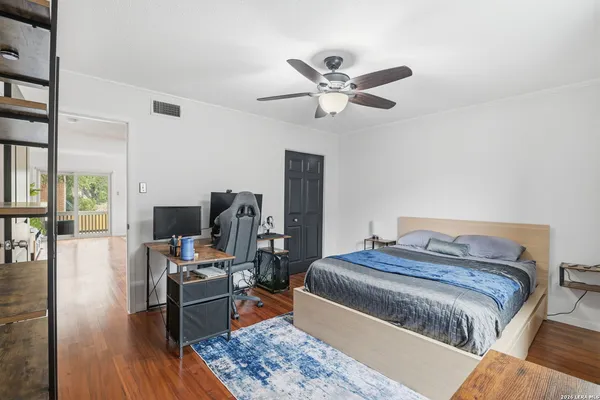 a bedroom with a bed and wooden floor