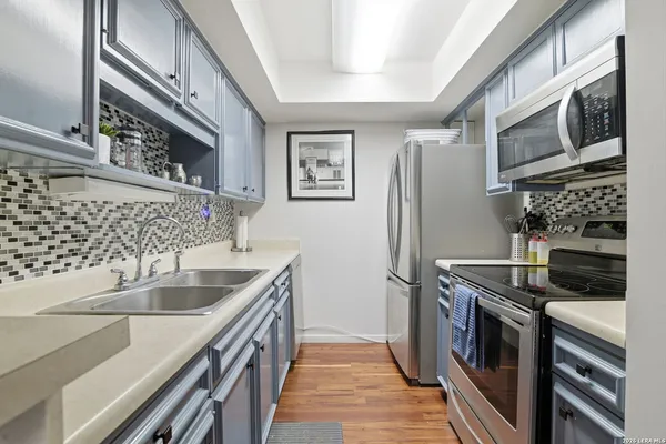 a kitchen with stainless steel appliances granite countertop a refrigerator and a sink