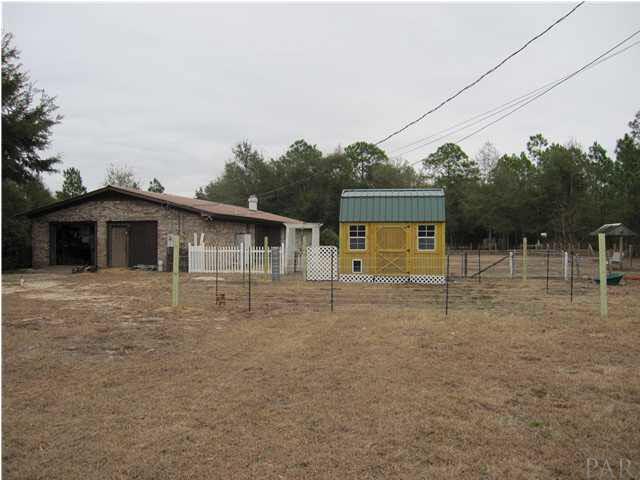 7863 Beneva Road Milton, FL 32583 - Photo 23 of 25 View of back yard from the west. Yard building and small fence around building does not convey. Belongs to tenant.