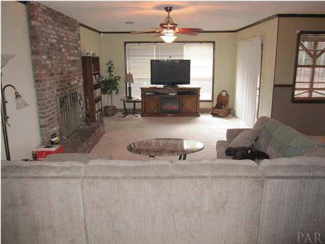7863 Beneva Road Milton, FL 32583 - Photo 7 of 25 View of family room from foyer. Sliding glass doors behind vertical blinds. Opens to large screened back patio.