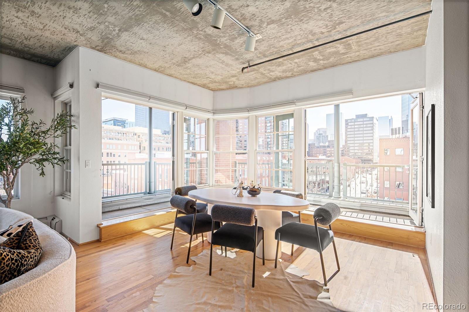 1499 Blake Street, Unit 6A Denver, CO 80202 - Photo 12 of 46 a dining room with furniture and wooden floor