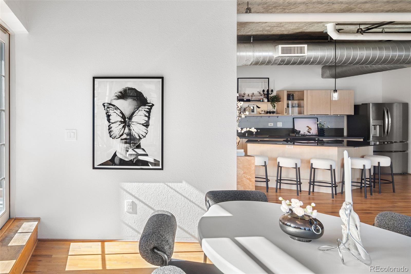 1499 Blake Street, Unit 6A Denver, CO 80202 - Photo 13 of 46 a living room with furniture a rug and kitchen view