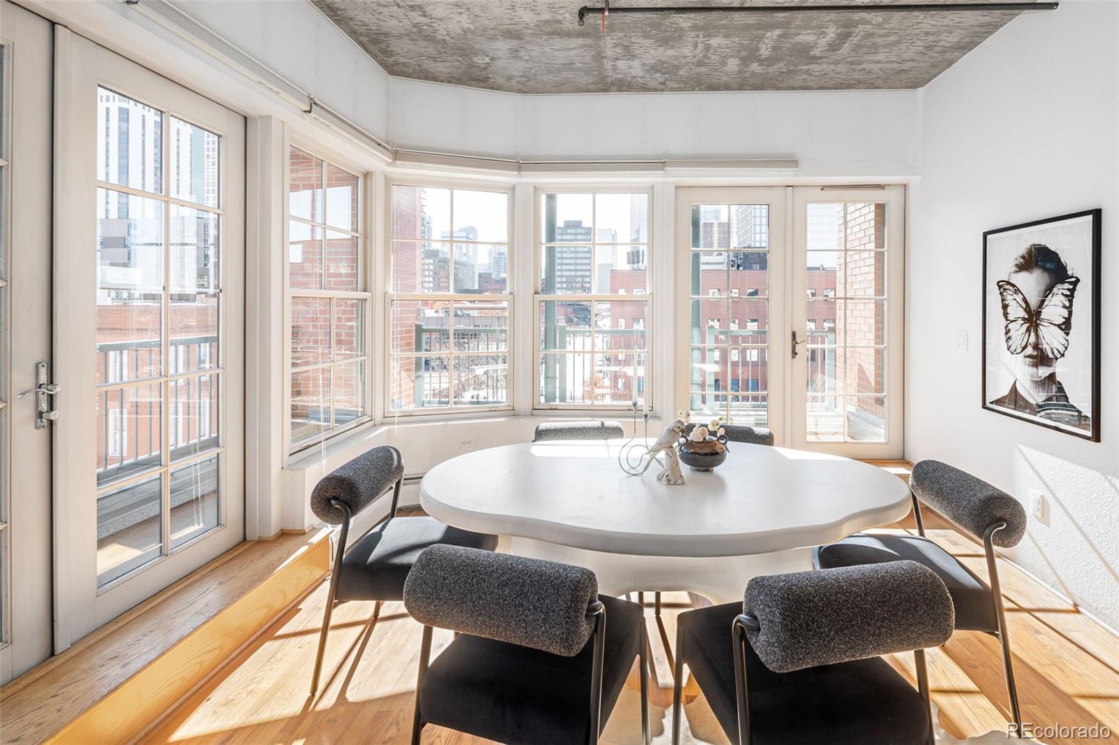 1499 Blake Street, Unit 6A Denver, CO 80202 - Photo 14 of 46 a dining room with furniture and wooden floor