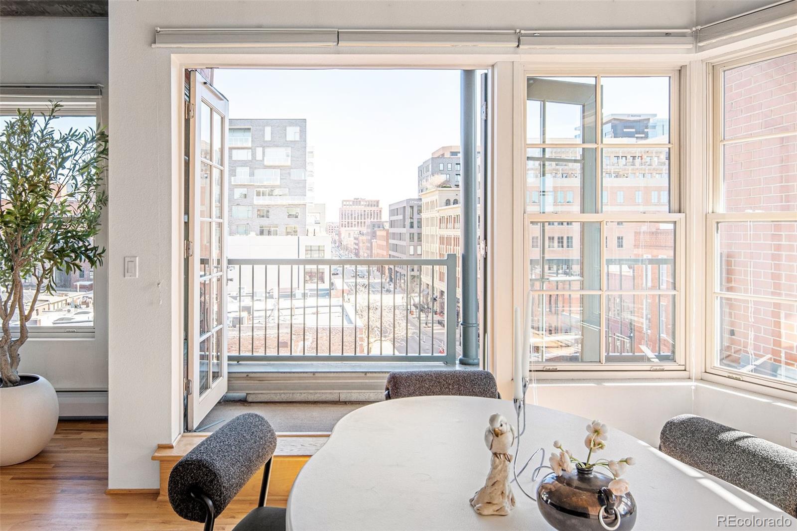 1499 Blake Street, Unit 6A Denver, CO 80202 - Photo 15 of 46 a living room with furniture and a large window