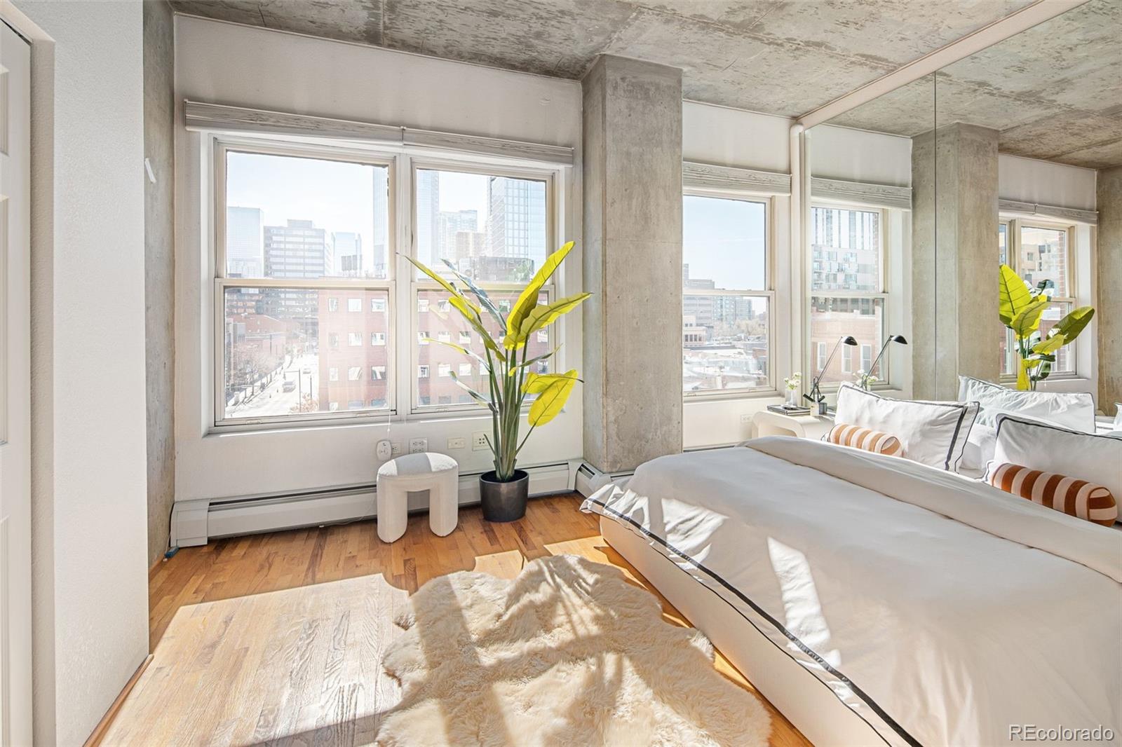 1499 Blake Street, Unit 6A Denver, CO 80202 - Photo 25 of 46 a bedroom with a bed and large windows