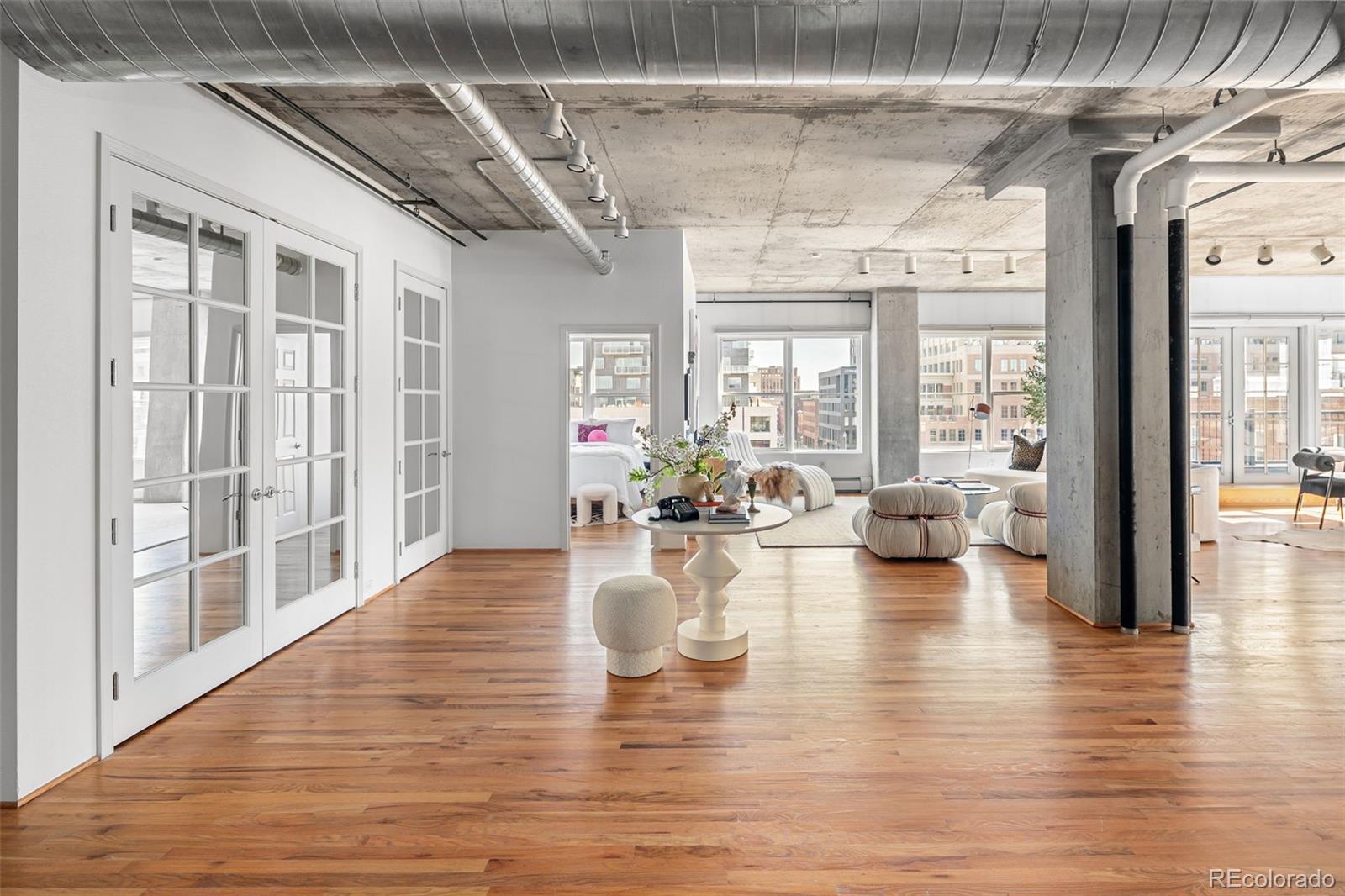 1499 Blake Street, Unit 6A Denver, CO 80202 - Photo 3 of 46 a view of a living room with hardwood floor and a large window