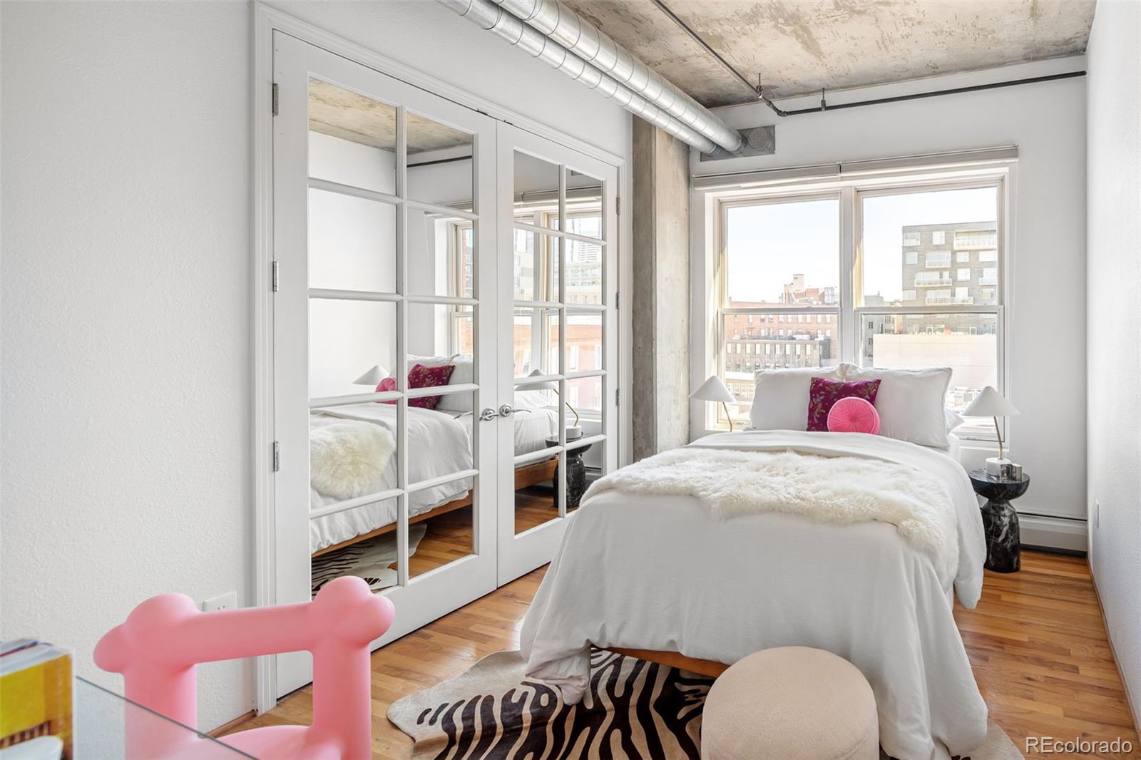 1499 Blake Street, Unit 6A Denver, CO 80202 - Photo 31 of 46 a bedroom with a bed and a window