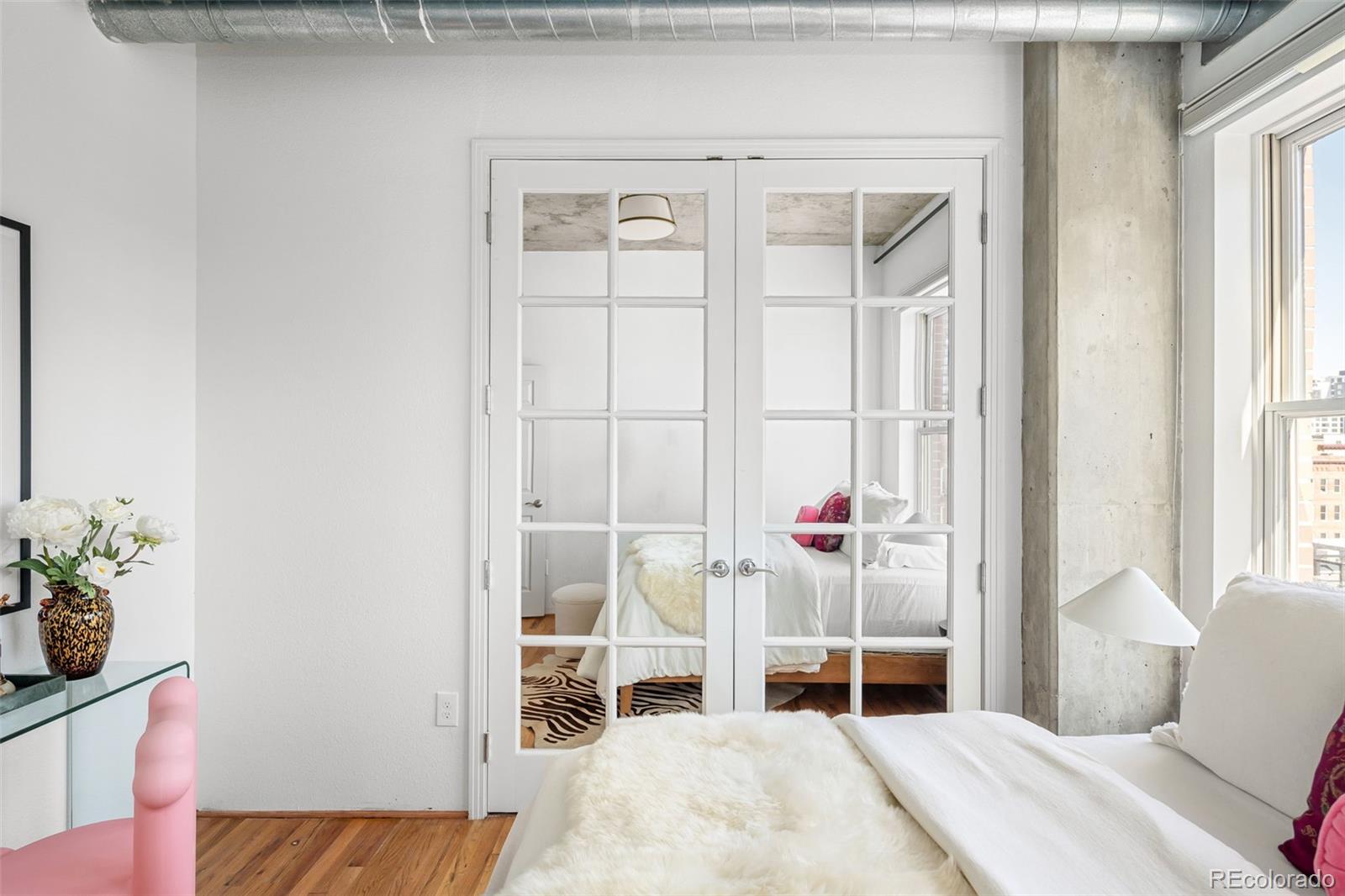 1499 Blake Street, Unit 6A Denver, CO 80202 - Photo 32 of 46 a bedroom with a bed and a window