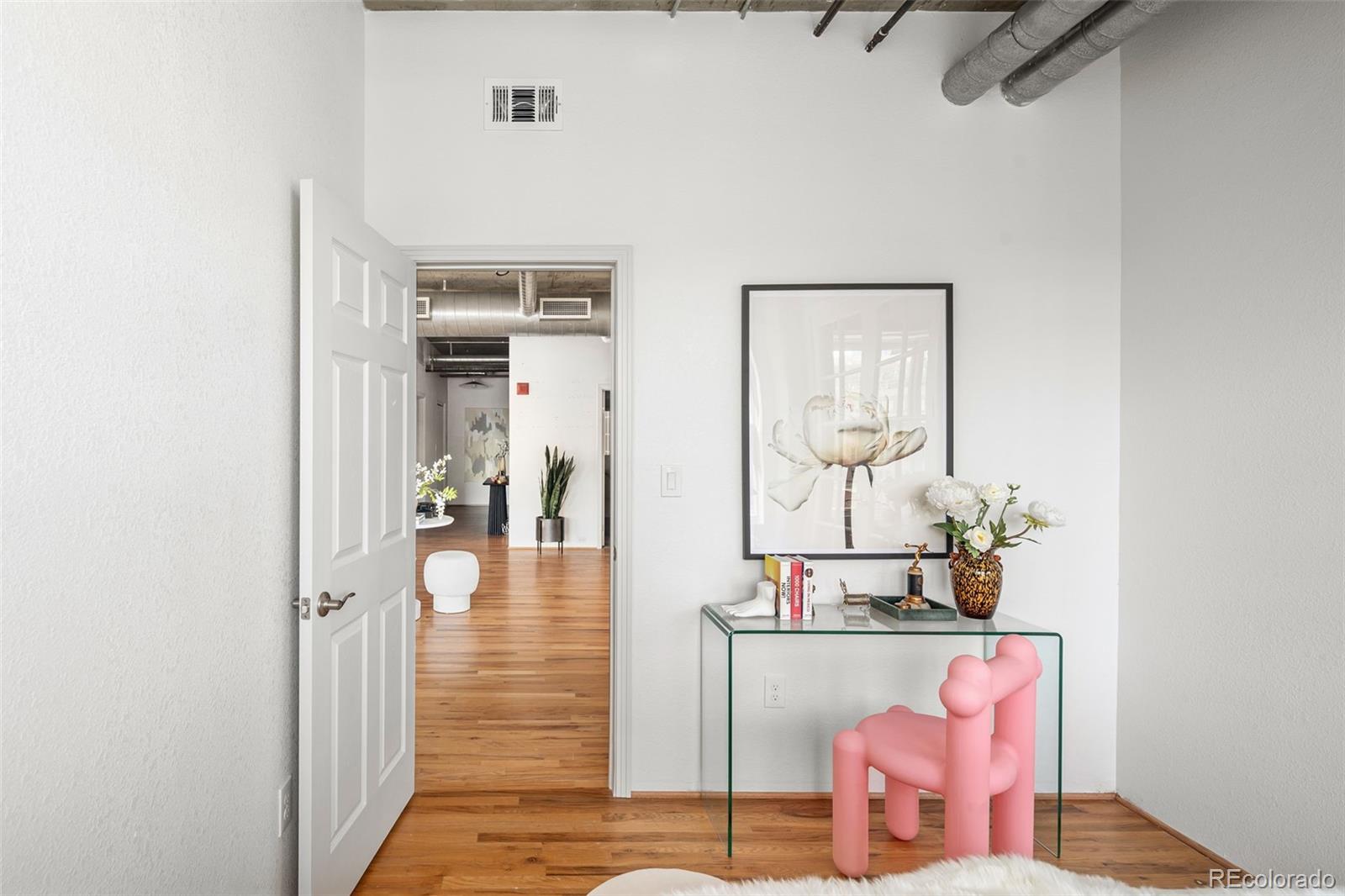 1499 Blake Street, Unit 6A Denver, CO 80202 - Photo 33 of 46 a hallway with a dining table and chairs