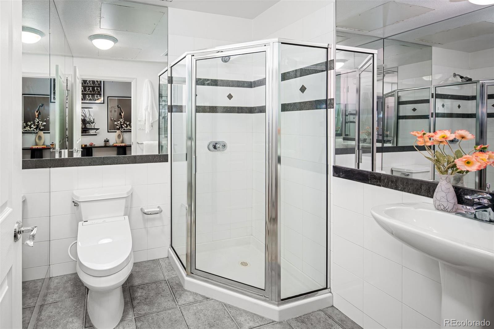 1499 Blake Street, Unit 6A Denver, CO 80202 - Photo 34 of 46 a bathroom with a sink a toilet and shower