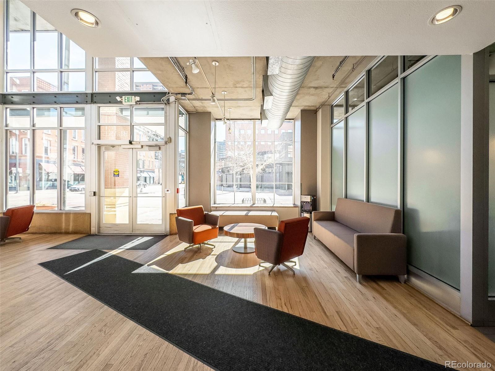 1499 Blake Street, Unit 6A Denver, CO 80202 - Photo 37 of 46 a living room with furniture and large windows