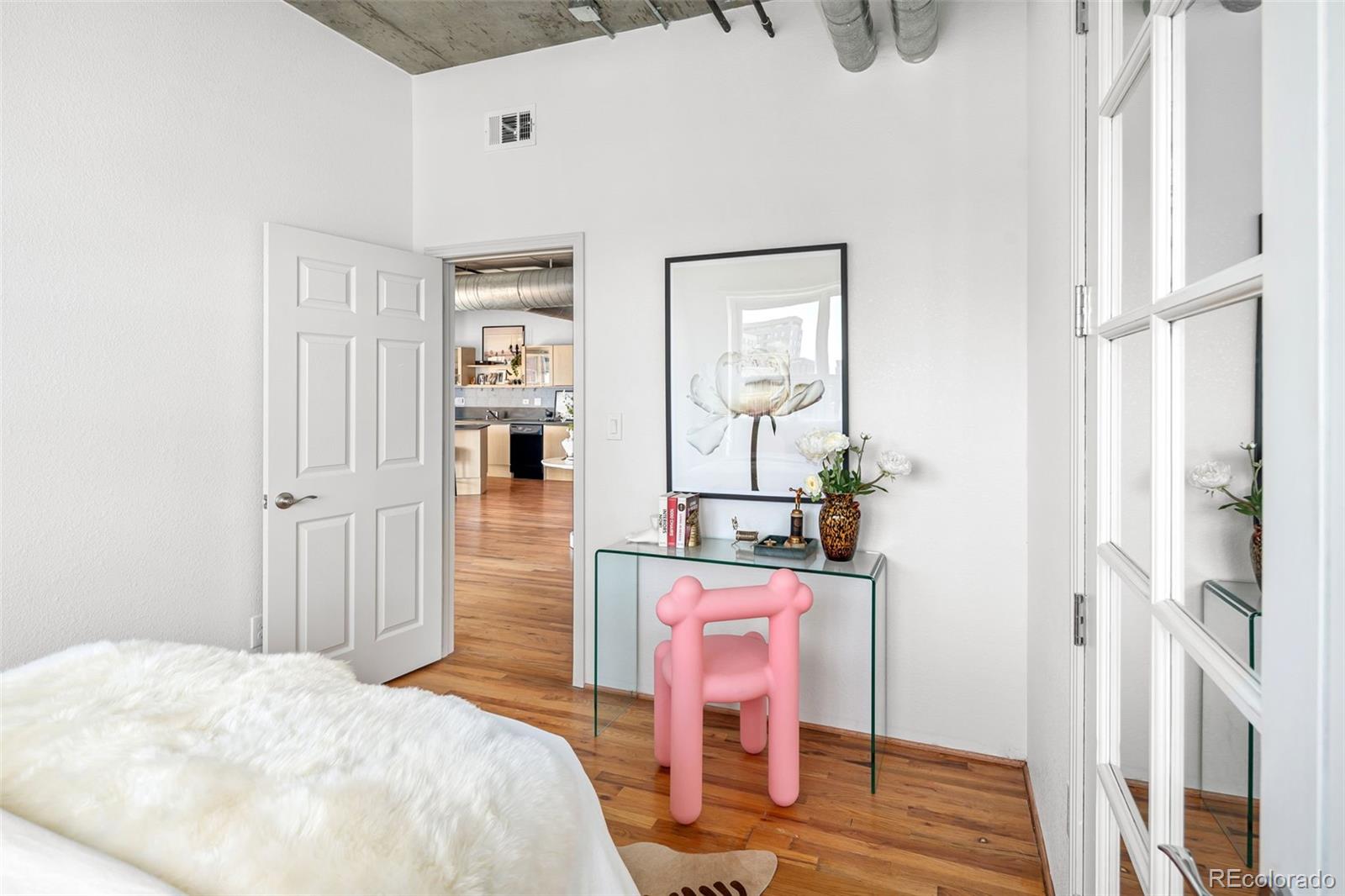1499 Blake Street, Unit 6A Denver, CO 80202 - Photo 42 of 46 a bedroom with a bed and a dresser