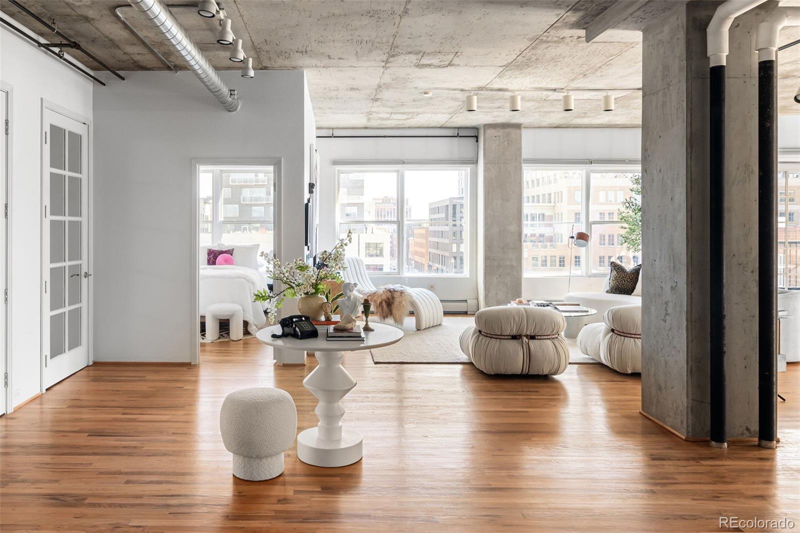 1499 Blake Street, Unit 6A Denver, CO 80202 - Photo 5 of 46 a living room with furniture and wooden floor