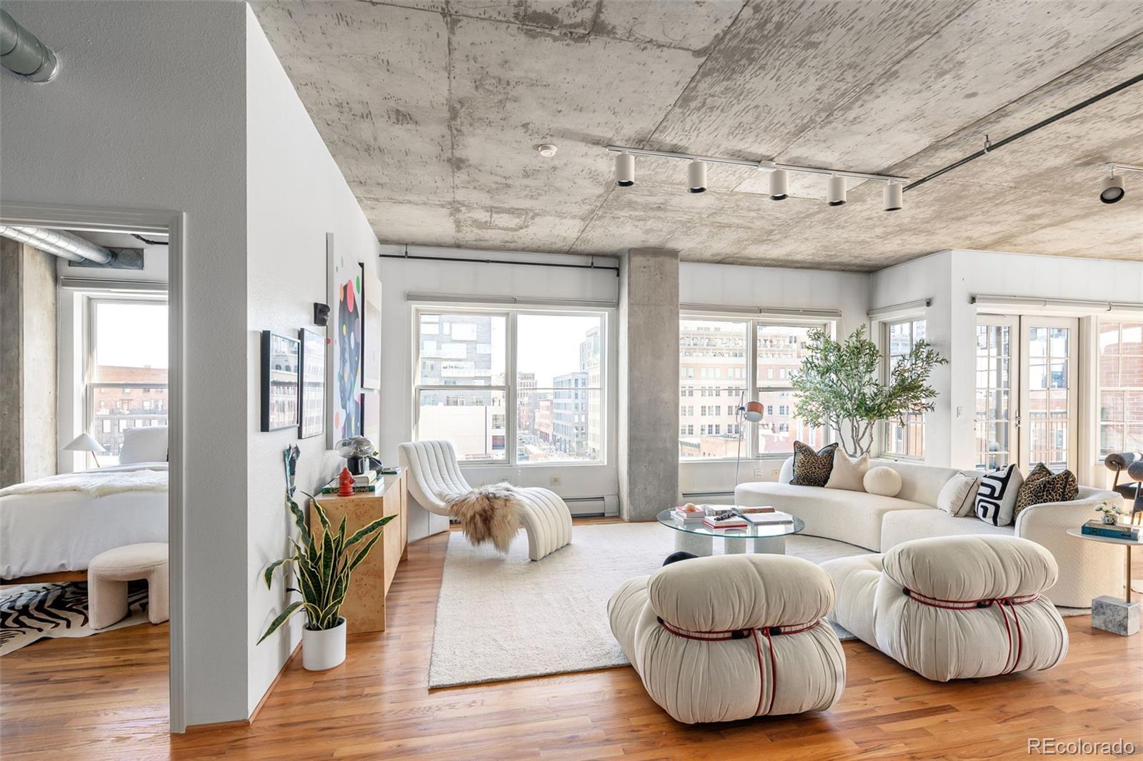 1499 Blake Street, Unit 6A Denver, CO 80202 - Photo 6 of 46 a living room with furniture and a large window