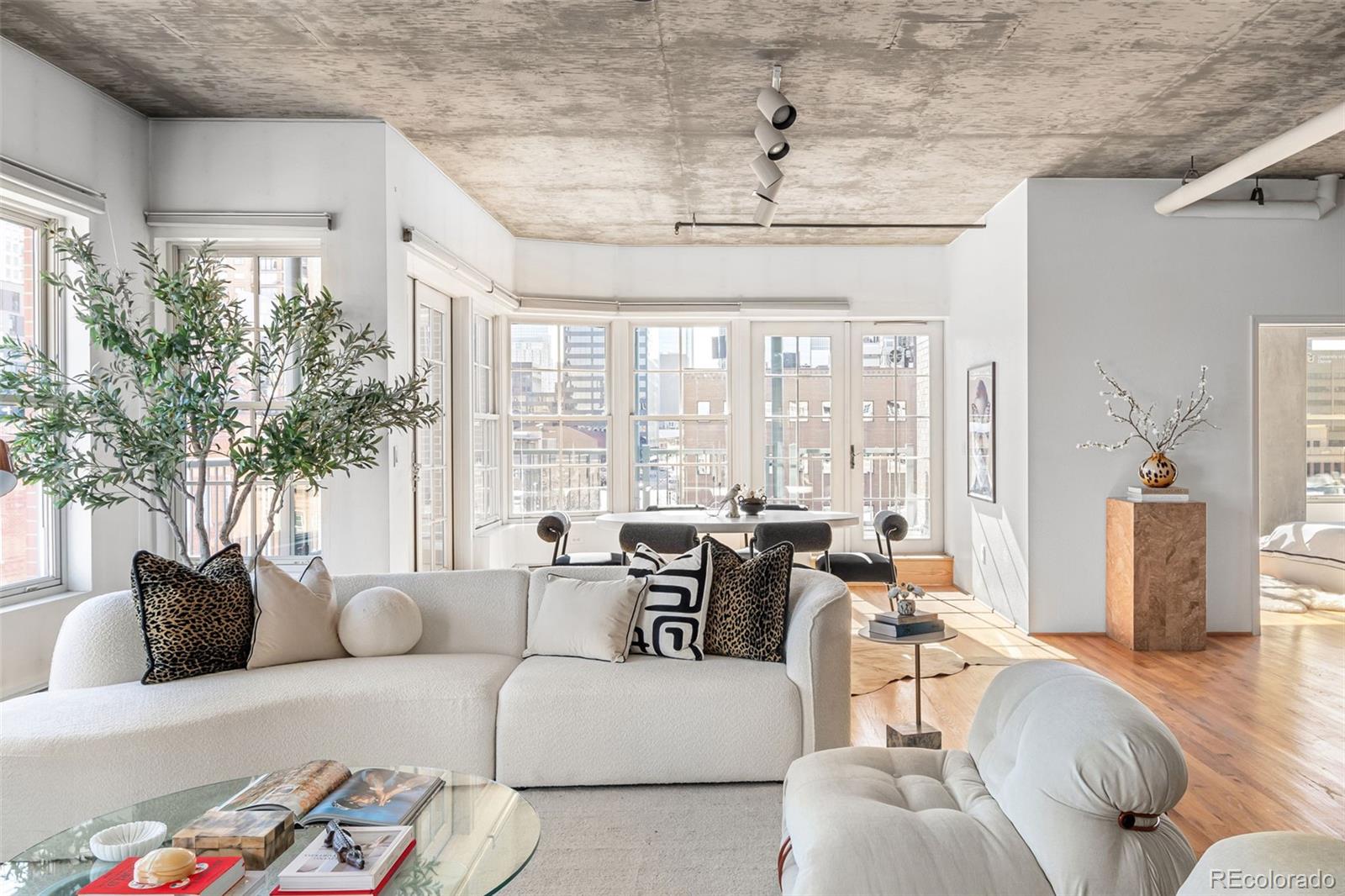 1499 Blake Street, Unit 6A Denver, CO 80202 - Photo 10 of 46 a living room with furniture and a large window