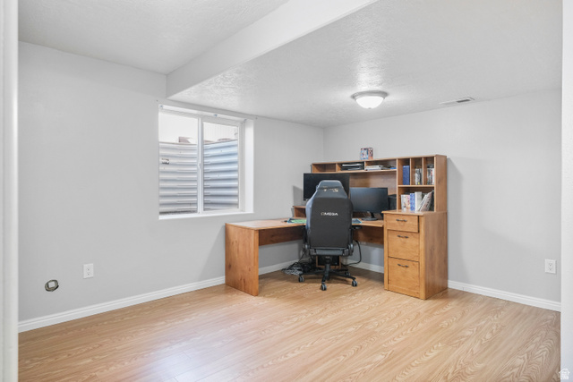 860 West 2980th Street South Logan, UT 84321 - Photo 26 of 38 Room featuring wood-finish flooring, light grey painted walls, and white baseboards
