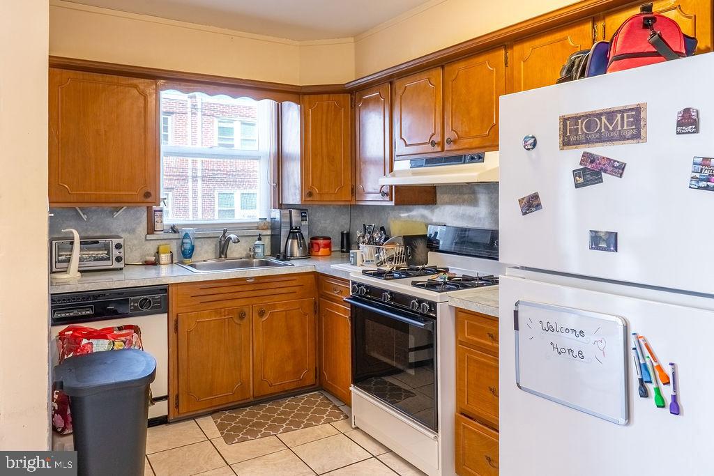 739 Fairfax Road Drexel Hill, PA 19026 - Photo 7 of 18 a kitchen with stainless steel appliances granite countertop a stove a sink and a refrigerator