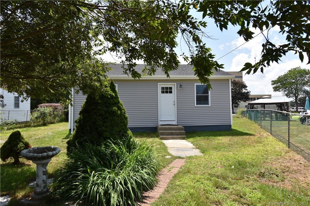Front view of newly renovated ranch with fenced in yard