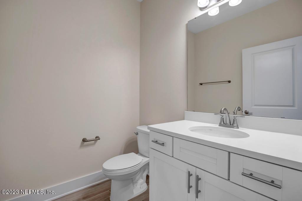 3666 Eunice Road Jacksonville, FL 32250 - Photo 18 of 32 a bathroom with a sink a toilet and mirror