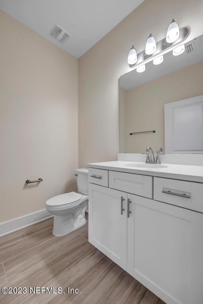 3666 Eunice Road Jacksonville, FL 32250 - Photo 19 of 32 a bathroom with a sink a toilet and a mirror