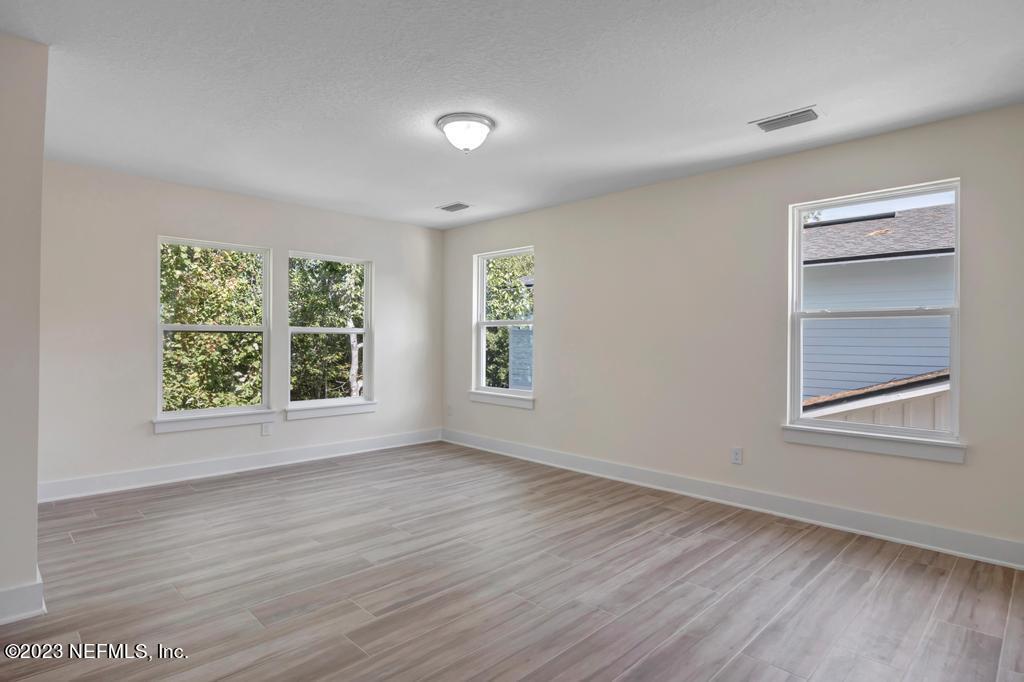 3666 Eunice Road Jacksonville, FL 32250 - Photo 20 of 32 a view of an empty room with wooden floor and a window