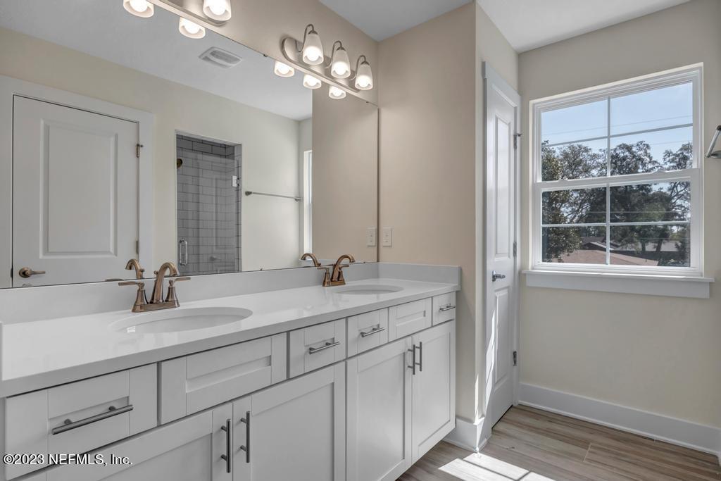 3666 Eunice Road Jacksonville, FL 32250 - Photo 23 of 32 a bathroom with double sink and a mirror