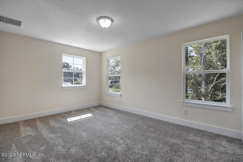 3666 Eunice Road Jacksonville, FL 32250 - Photo 26 of 32 an empty room with windows