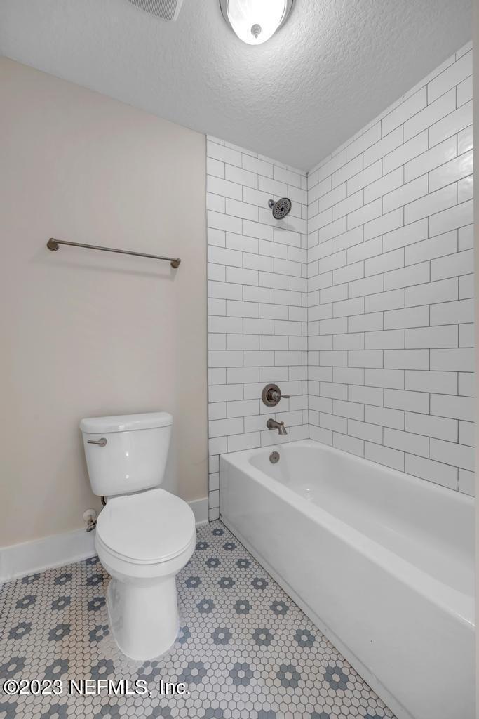 3666 Eunice Road Jacksonville, FL 32250 - Photo 31 of 32 a white toilet sitting next to a bath tub