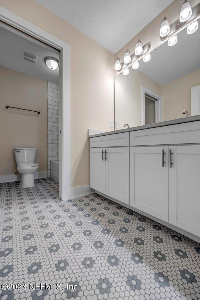 3666 Eunice Road Jacksonville, FL 32250 - Photo 32 of 32 a bathroom with a sink a toilet and a mirror